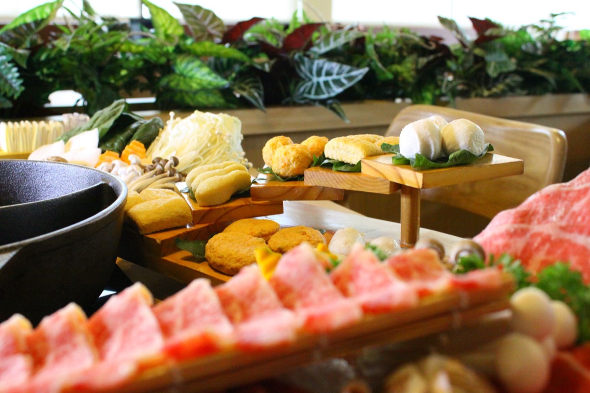 Sichuan hot pot ingredients on wooden tray