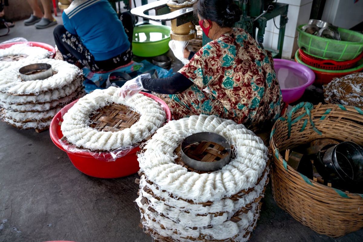 Handmade rice noodles and ingredients in ethnic market