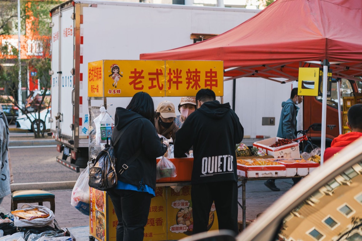 Street vendor selling hot pot ingredients in a Chinese city market